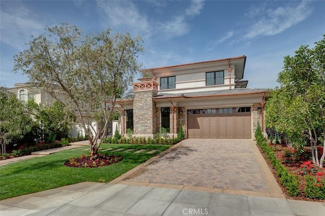 view of front of property featuring a garage and a front lawn