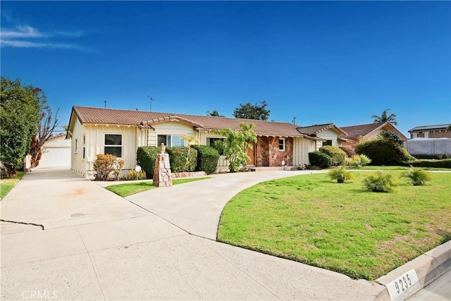 view of front of home with a garage and a front lawn