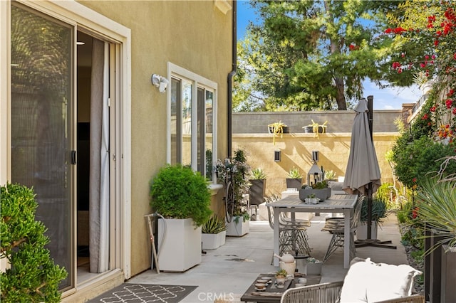 view of patio / terrace with outdoor dining space and fence