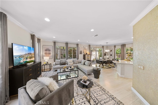 living area featuring baseboards, visible vents, crown molding, light wood-style floors, and recessed lighting