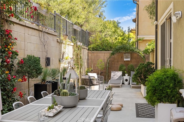 view of patio / terrace with outdoor dining area and fence