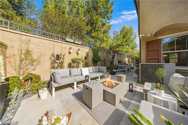 view of patio featuring an outdoor living space with a fire pit and a fenced backyard