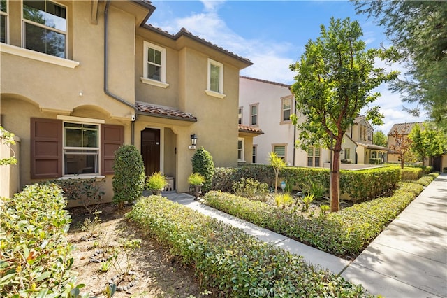 mediterranean / spanish-style house with a tiled roof and stucco siding