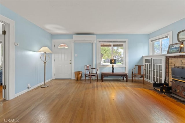 entrance foyer featuring hardwood / wood-style flooring and a wall unit AC