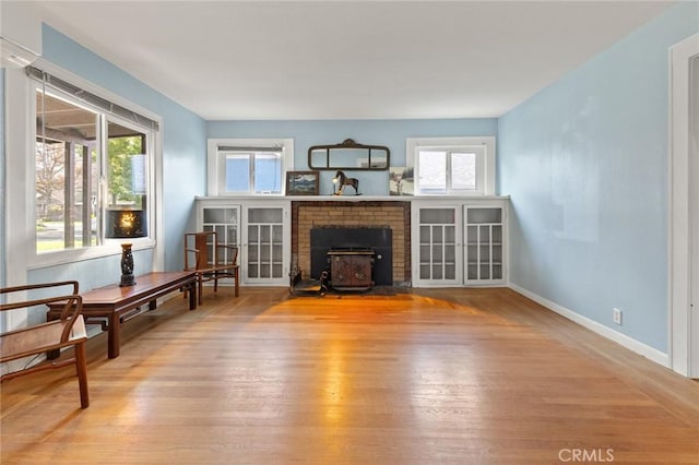 living room featuring hardwood / wood-style flooring and a wood stove