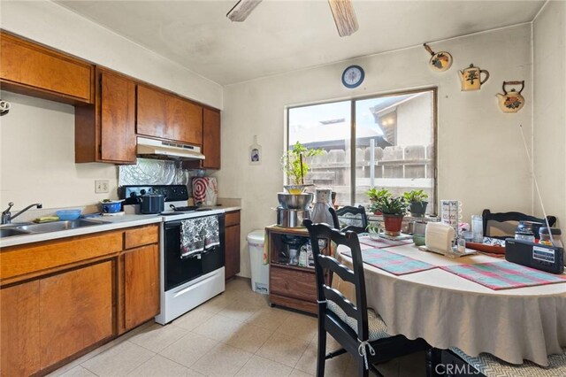 1062 Humboldt Ave, Chico, CA 95928 - kitchen featuring ceiling fan, sink, and electric range