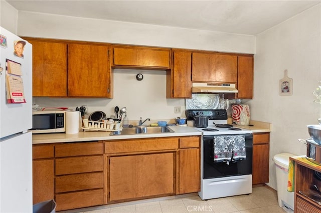 1062 Humboldt Ave, Chico, CA 95928 - kitchen with sink, light tile patterned floors, and white appliances