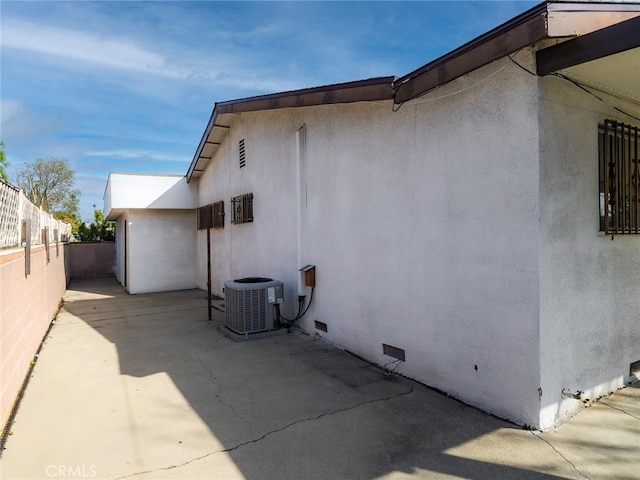 view of home's exterior with a patio and central AC