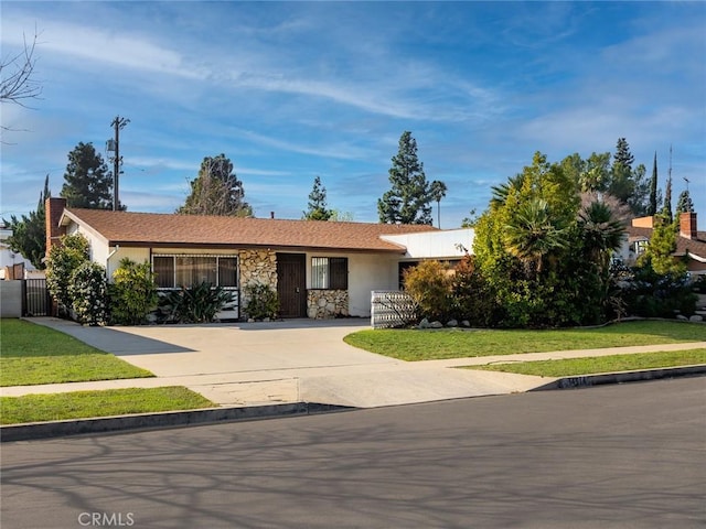 ranch-style home with a front lawn