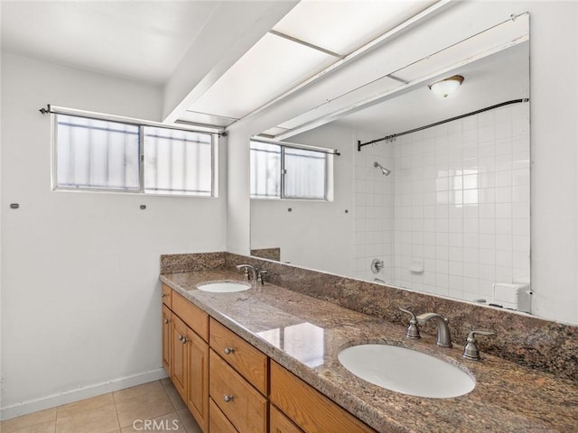 bathroom with vanity, tiled shower, and tile patterned floors