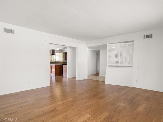 unfurnished living room featuring light wood-type flooring