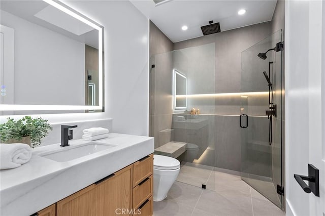 bathroom with vanity, tile patterned flooring, a shower with door, and toilet