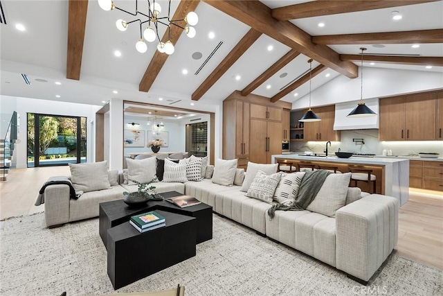 living room featuring high vaulted ceiling, beam ceiling, a chandelier, and light hardwood / wood-style floors