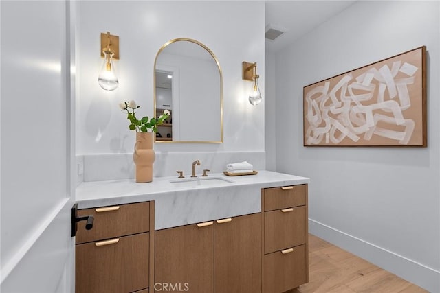 bathroom featuring vanity and hardwood / wood-style floors