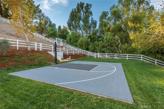 view of basketball court with a lawn