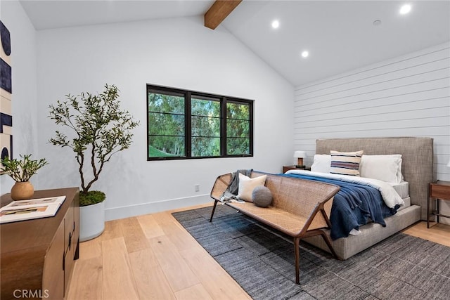 bedroom featuring hardwood / wood-style floors, high vaulted ceiling, and beamed ceiling