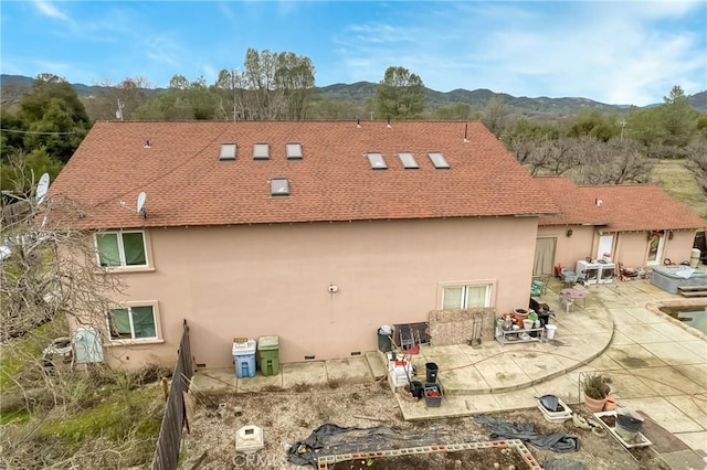 exterior space featuring a mountain view and a patio area