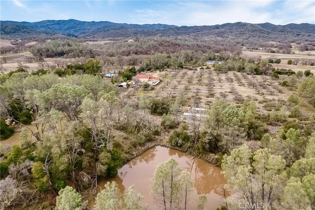 aerial view featuring a water and mountain view