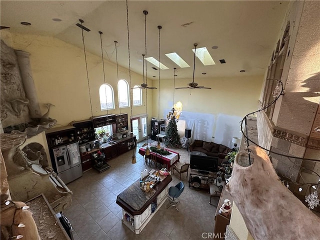 misc room featuring a skylight, high vaulted ceiling, and ceiling fan