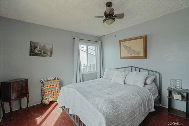 bedroom featuring a textured ceiling, a ceiling fan, and baseboards