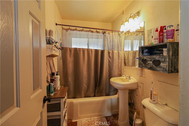 full bathroom featuring toilet and shower / tub combo with curtain