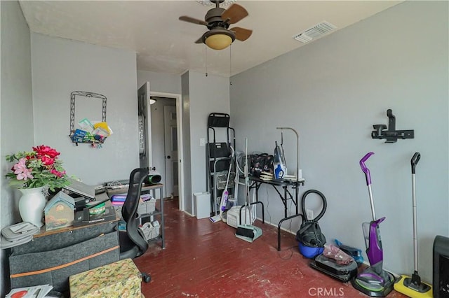 exercise room with visible vents and a ceiling fan