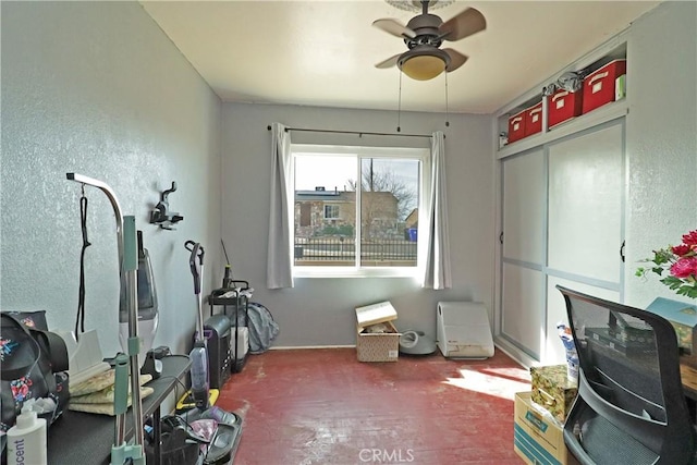 exercise room with ceiling fan