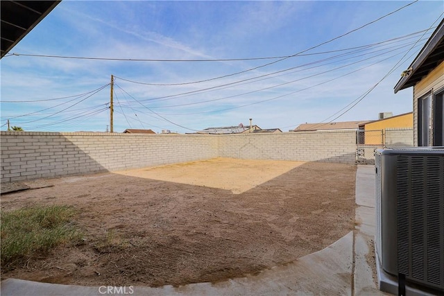 view of yard featuring a fenced backyard and central AC unit