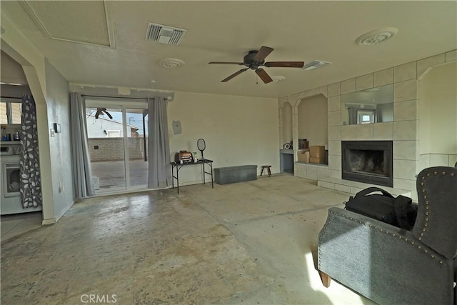 view of patio with washer / clothes dryer, a fireplace, visible vents, and a ceiling fan