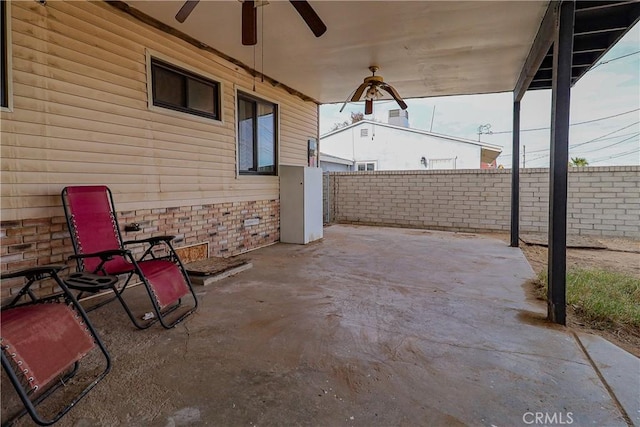 view of patio with a fenced backyard and a ceiling fan