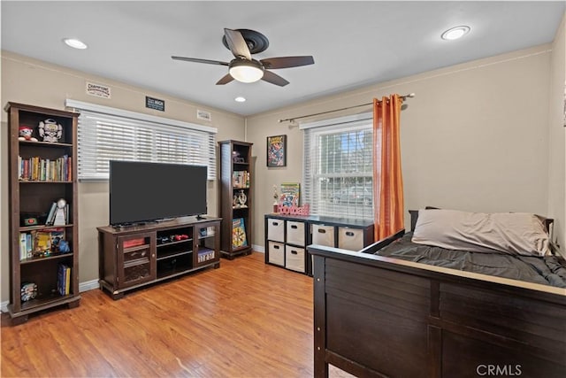 bedroom with light hardwood / wood-style flooring and ceiling fan