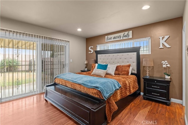 bedroom featuring wood-type flooring and access to exterior