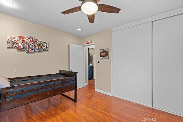 interior space featuring hardwood / wood-style flooring, ceiling fan, and a closet