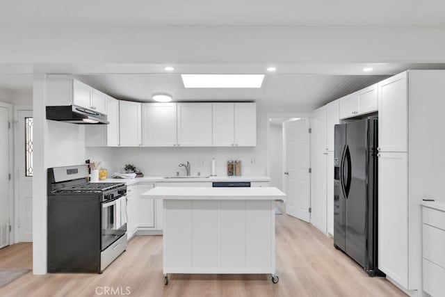 kitchen with white cabinets, black fridge with ice dispenser, light hardwood / wood-style flooring, and stainless steel gas range oven