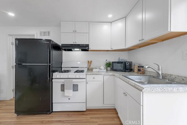 kitchen with white cabinetry, sink, light hardwood / wood-style floors, and black appliances