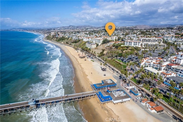 bird's eye view featuring a water view and a beach view