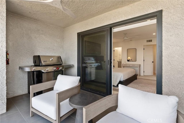 view of patio with area for grilling and ceiling fan