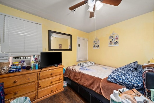 bedroom with a ceiling fan and dark wood-style flooring