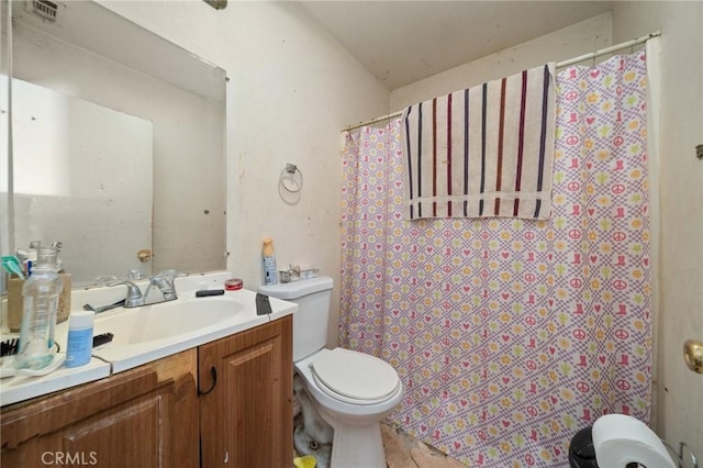bathroom with visible vents, toilet, vanity, and a shower with shower curtain