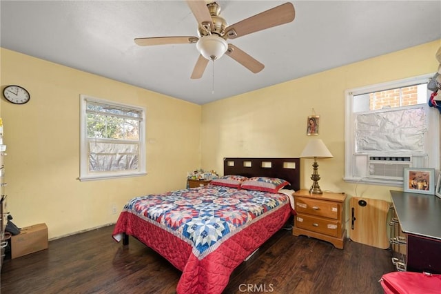 bedroom with dark wood-style flooring, ceiling fan, and cooling unit