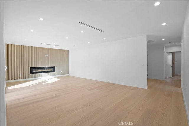 unfurnished living room with light wood-type flooring