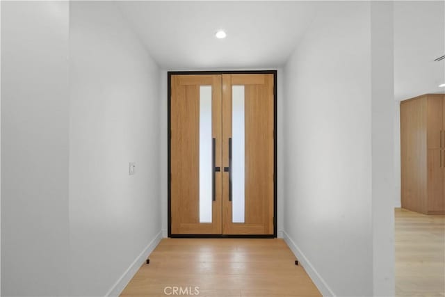 entryway with french doors and light hardwood / wood-style flooring