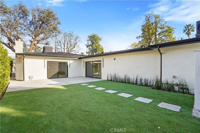 back of house featuring a yard and a patio