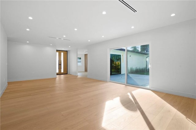 spare room featuring light hardwood / wood-style floors