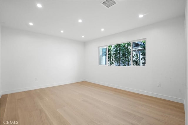 unfurnished room with light hardwood / wood-style floors