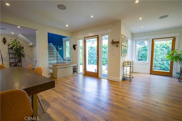 doorway to outside featuring recessed lighting, stairway, and wood finished floors