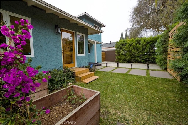 view of yard with a patio area, a garden, and fence