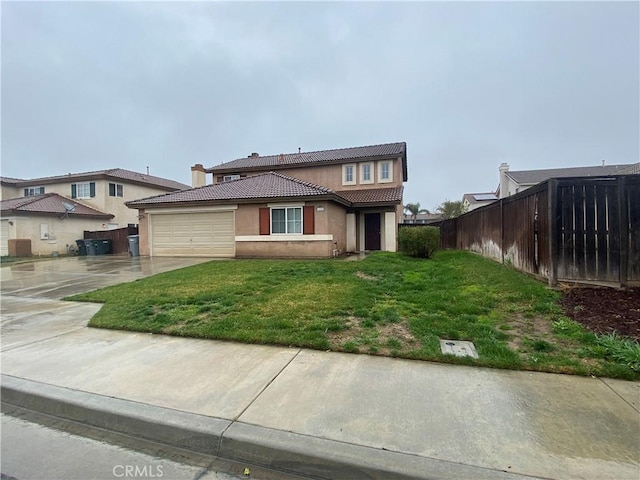 view of front of home with a garage and a front lawn