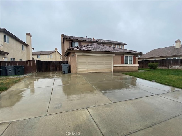 view of front of home featuring a garage and a front lawn