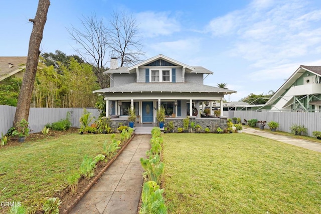 bungalow with a porch and a front lawn